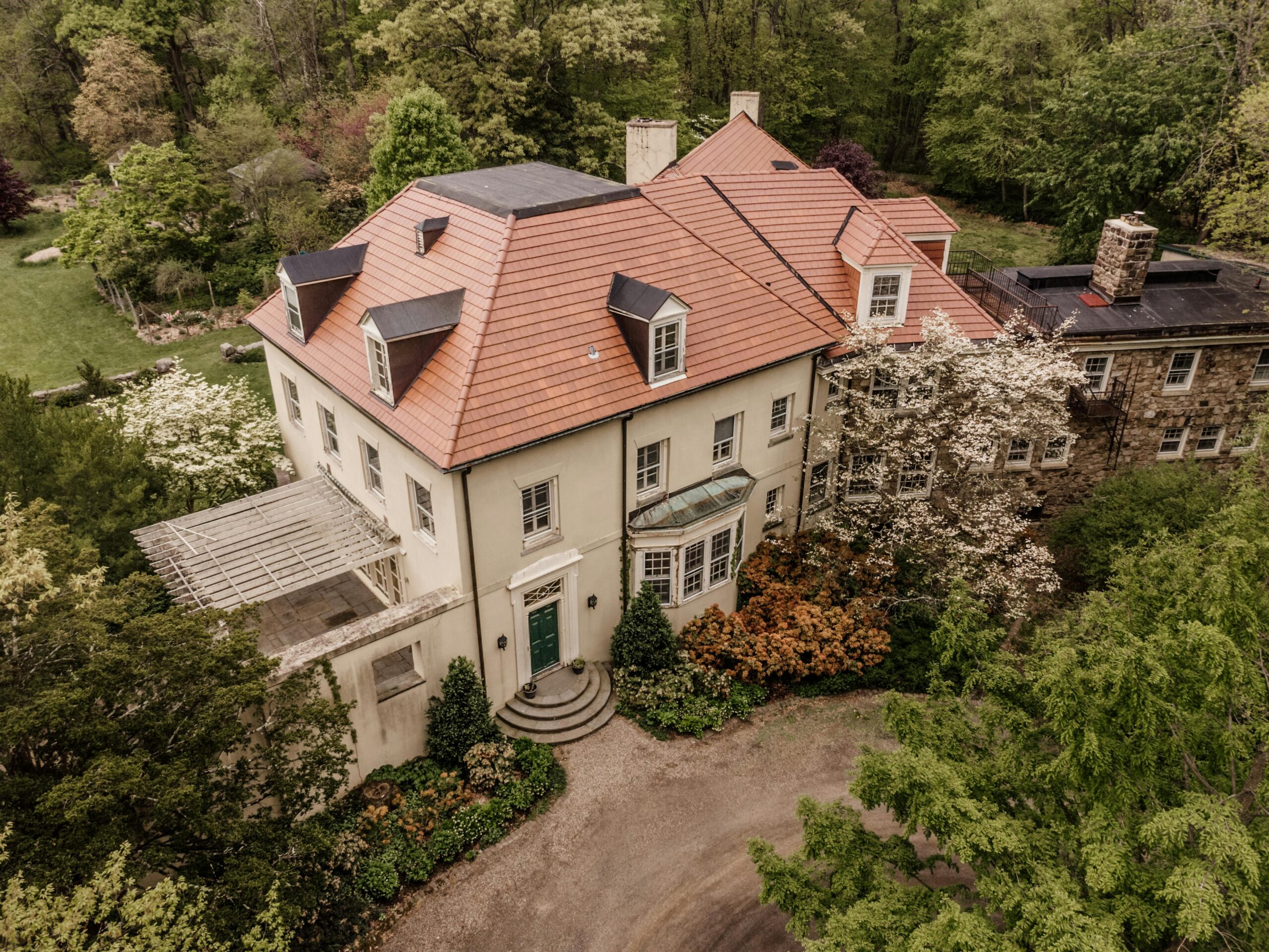Services Aerial view of a stately mansion surrounded by lush greenery in Bernardsville, NJ.