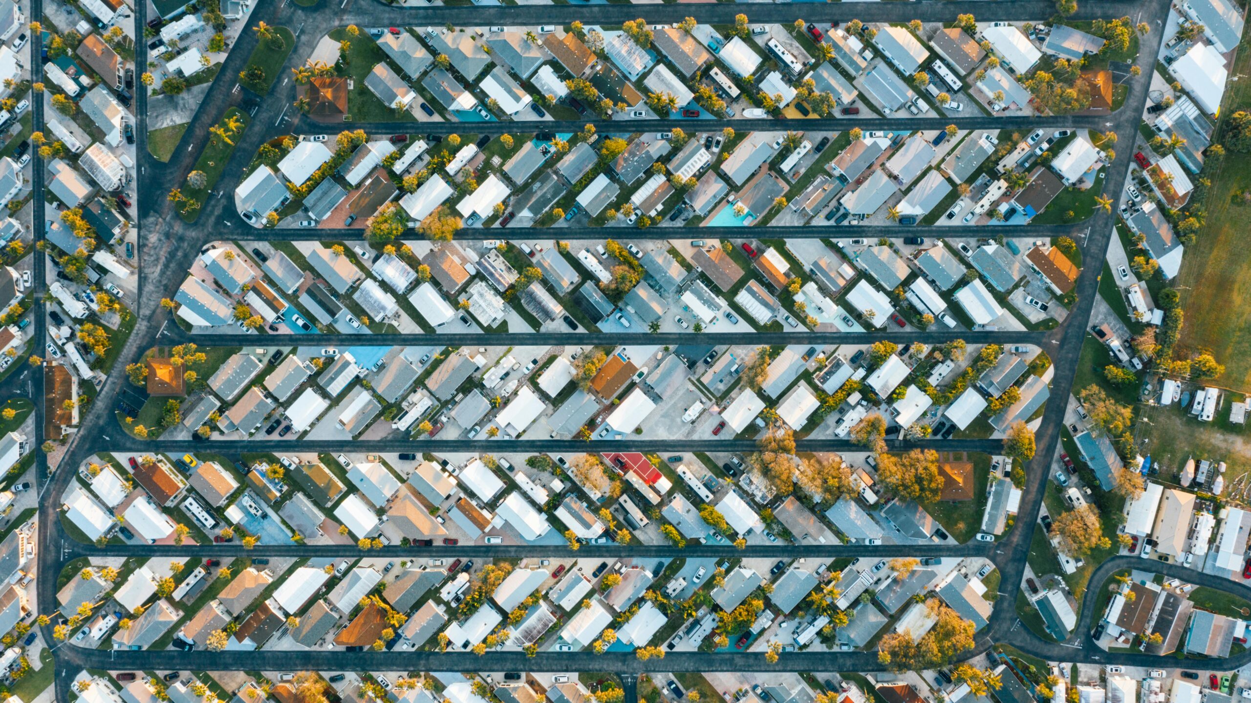 Services Drone view of modern buildings located in rows between roads in suburb of contemporary town on daytime